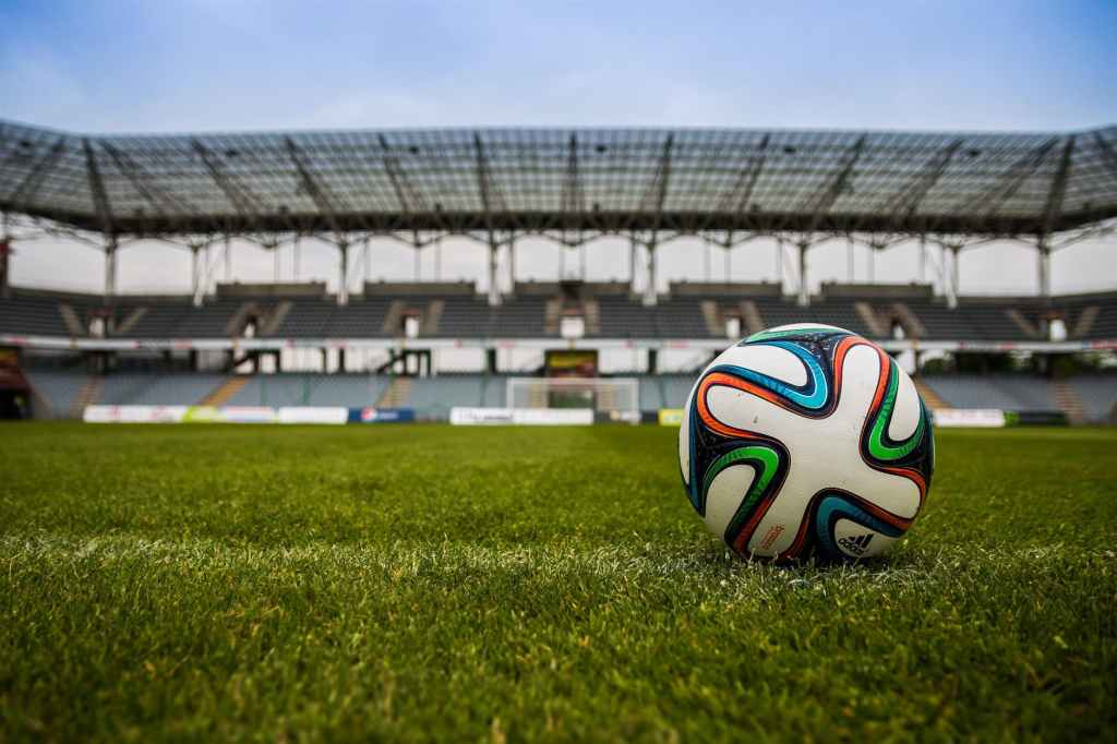 Gambar soccer ball on grass field during daytime
